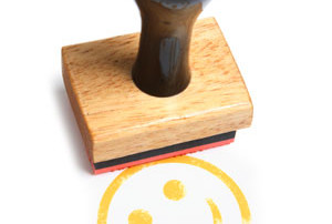 A Smiley Face Stamp In Yellow