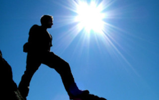 Silhouette Of A Man On A Mountain Peak