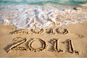 2010 and 2011 Is Written In The Sand. 2010 Is being Washed Away By A Wave