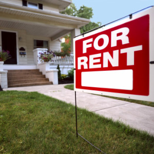 A For Rent Sign Is In Front Of A New Looking Home
