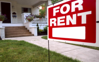 A For Rent Sign Is In Front Of A New Looking Home