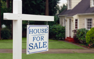 House For Sale Sign Infront of House