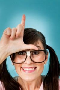 Person making the Loser sign on her head.