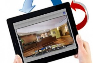 Hands Holding Ipad With Two arrows Indicating That You Can Rotate It. Home Tour Is On The Screen