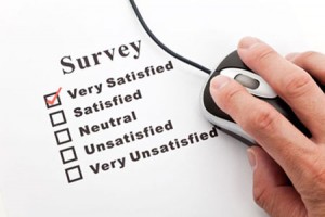Survey on a paper and  a hand on a computer mouse