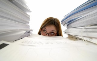 Woman buried in stacks of files