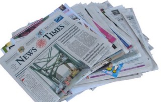 A Stack Of Various Newspapers