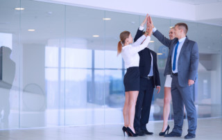 Business people with their hands together in a circle .