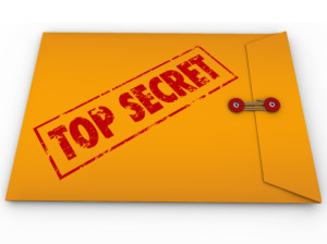 A yellow envelope with a red stamp with the words Top Secret conveying that the information inside is a secret, private, confidential, restricted message