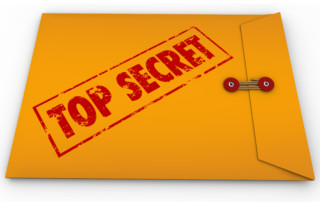 A yellow envelope with a red stamp with the words Top Secret conveying that the information inside is a secret, private, confidential, restricted message