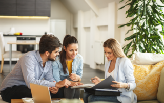 Female Real Estate agent offer home ownership and life insurance to young couple.