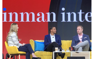 Robert Reffkin -Compass CEO (middle) and Josh Team -Keller Williams President (right) being interviewed by woman (left)