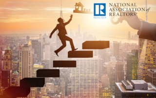 man walking up stairs reaching for key that looks like home with NAR logo