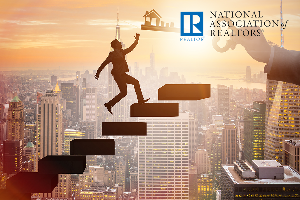 man walking up stairs reaching for key that looks like home with NAR logo
