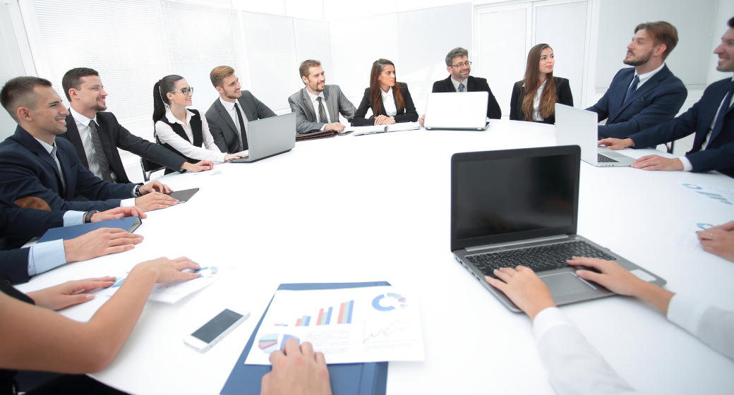 image of a white circle table with people around it