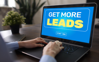 laptop that has "GET MORE LEADS" on the screen