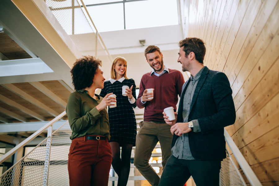 It's coffee o'clock! Group of coworkers having a coffee break