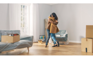 Two people hugging in their new home