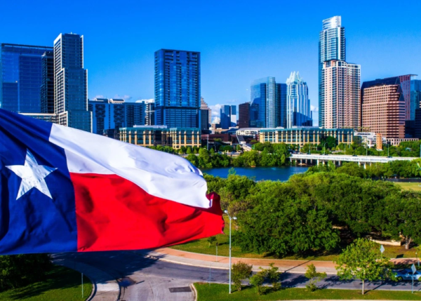 city skyline in texas with the texas flag in the foreground