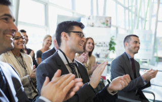 Audience clapping at conference