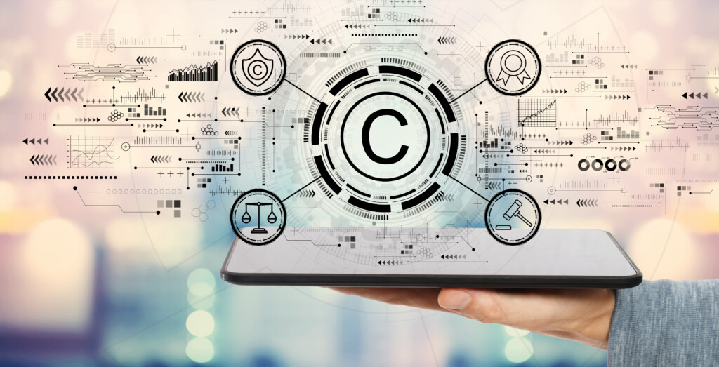 Copyright concept with man holding a tablet computer