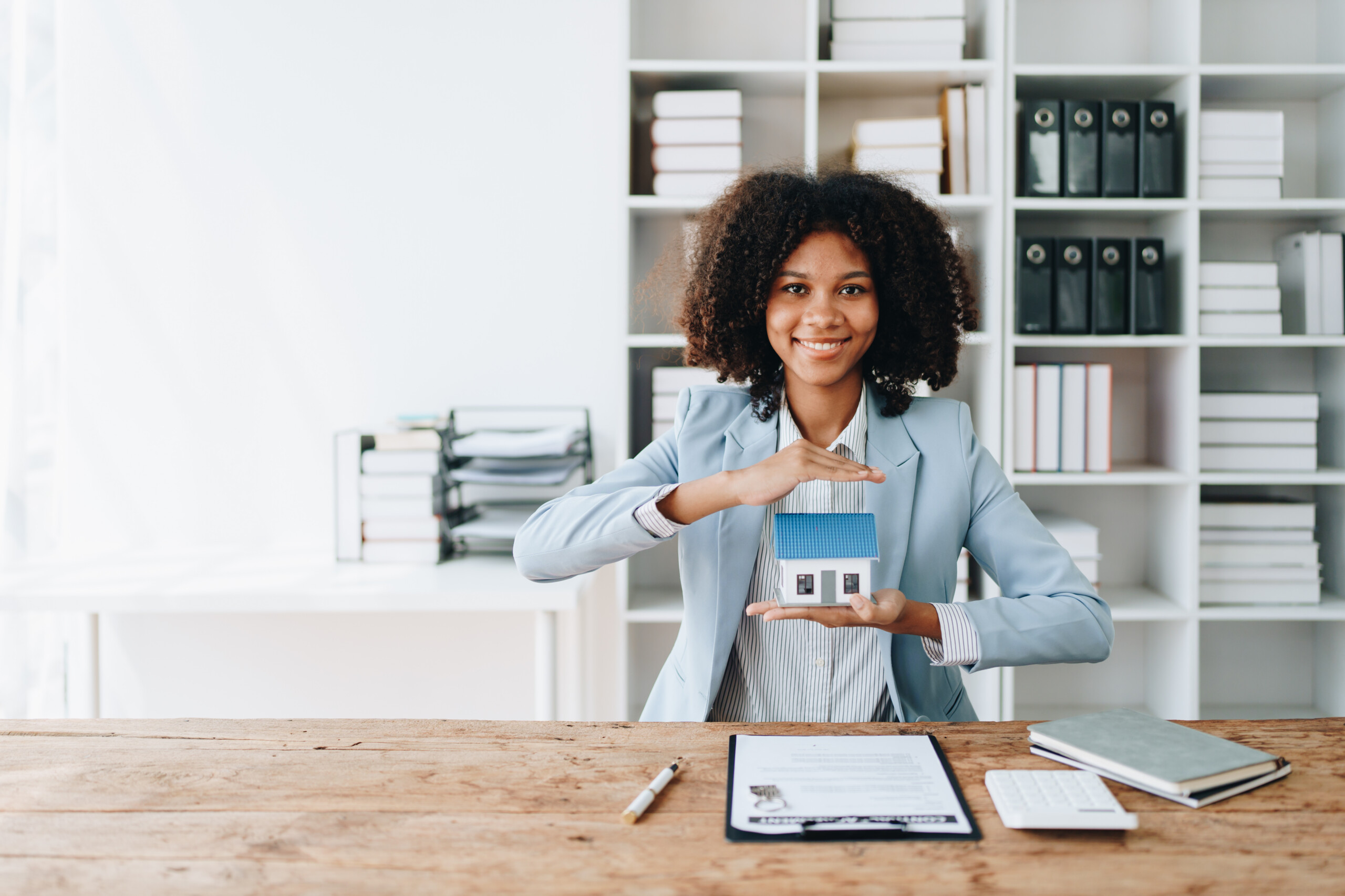 Real estate african american, Agent, buy and sell land, property tax, show the concept of protecting the house to insure the risk of damage to the home. insurance concepts.