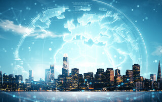 Digital globe hologram floats above a modern city skyline under a blue sky, representing smart city and global tech connectivity concepts